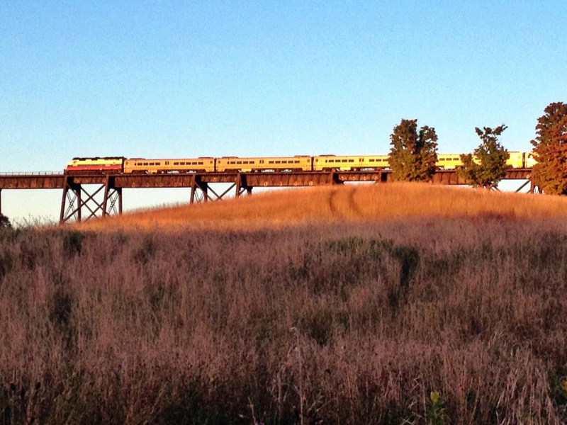 The train travels through Cornwall on the trestle. Sunset. 